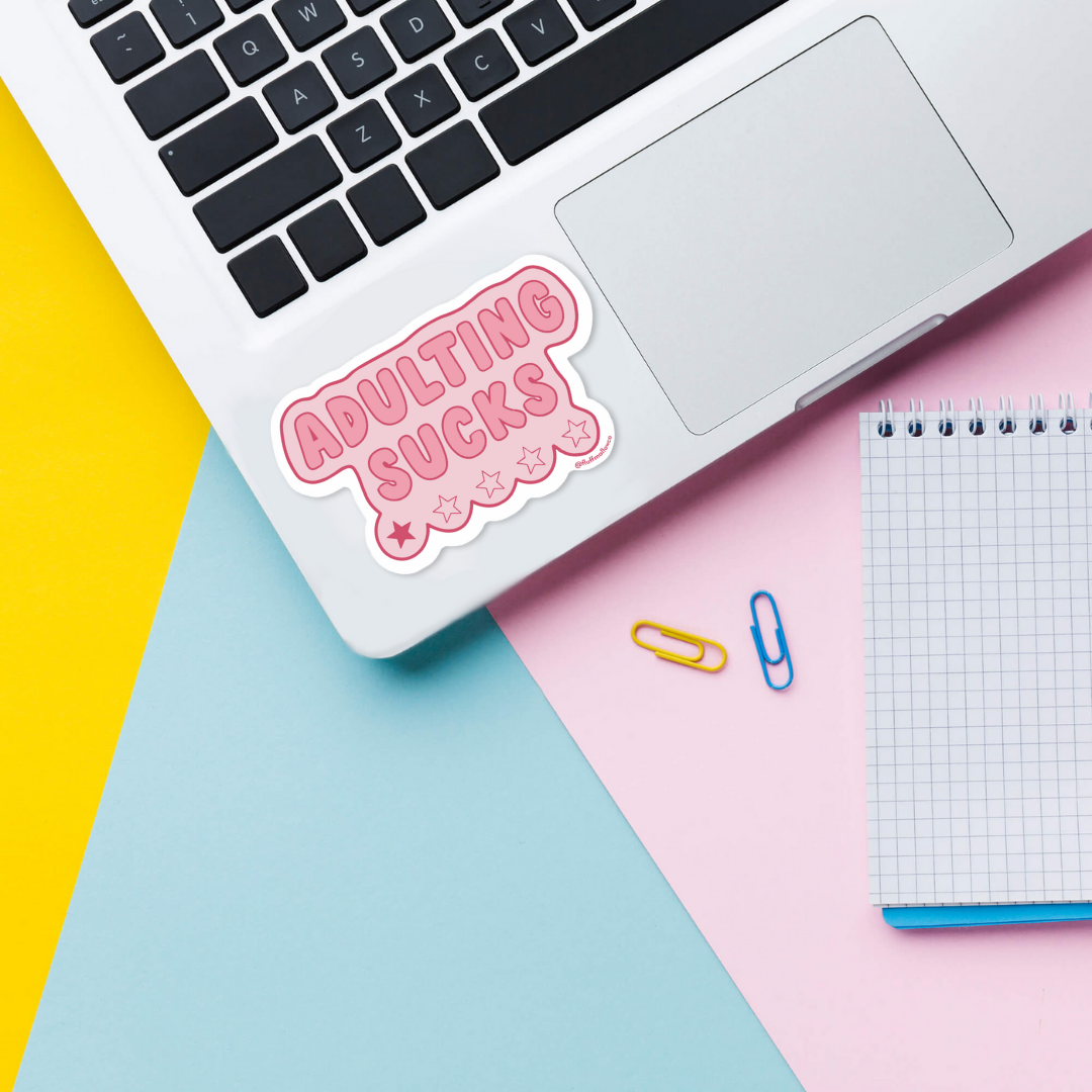 Adulting sucks vinyl sticker on laptop