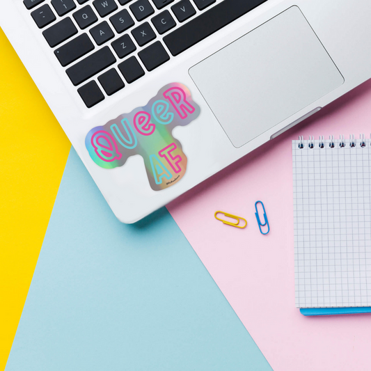 Queer af holographic vinyl sticker on laptop