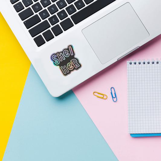 she/they holographic vinyl sticker on laptop