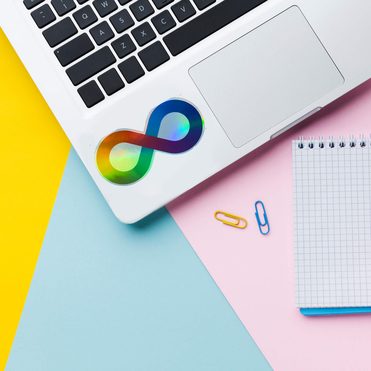Rainbow infinity neurodiversity holographic vinyl sticker on laptop