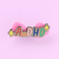 AuDHD autistic + ADHD glitter enamel pin