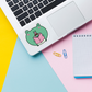 frog reading sticker on laptop