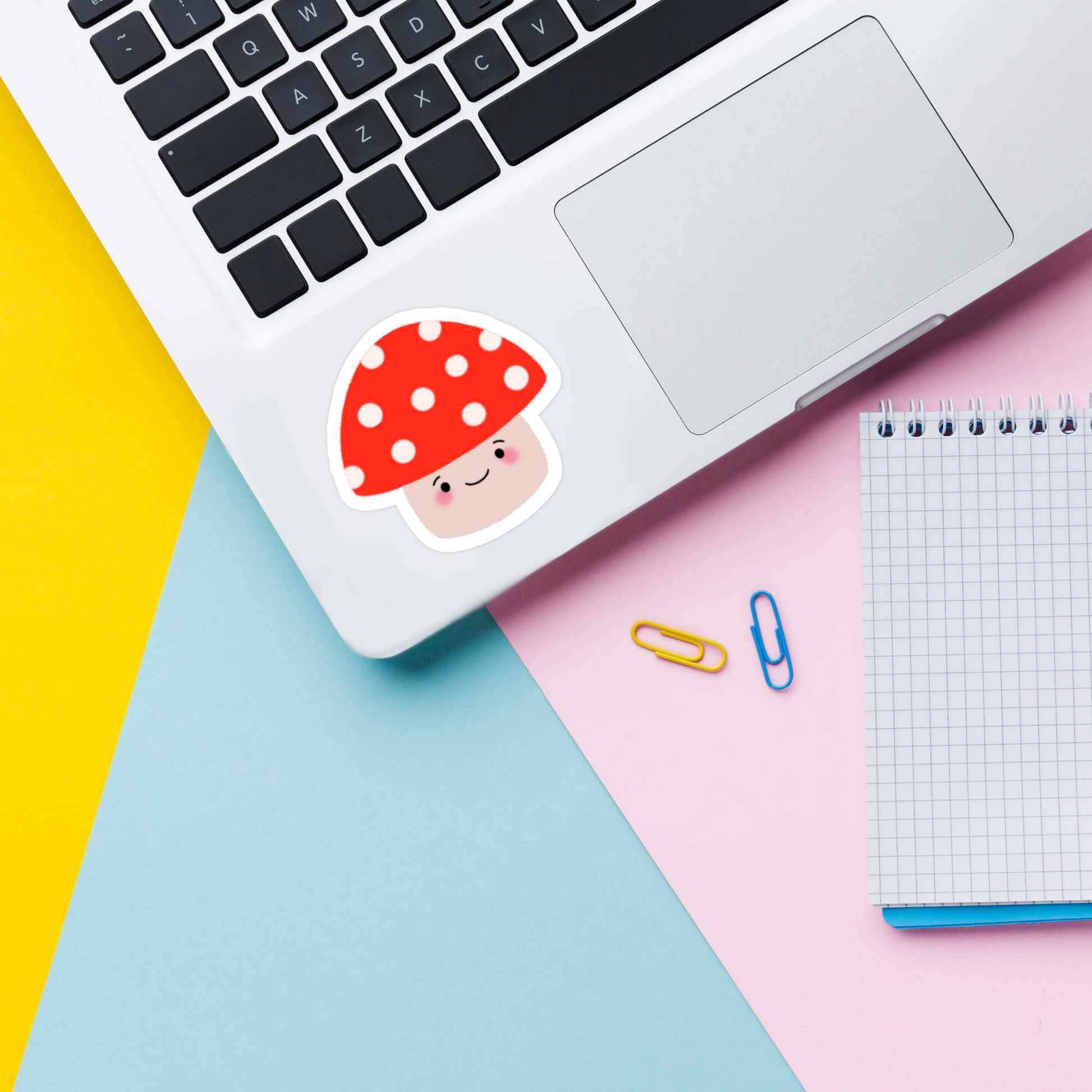 Cute red kawaii mushroom sticker on laptop
